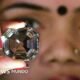Una mujer sostiene una copia del diamante Koh-i-Noor.