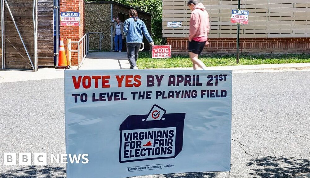 Señal que dice "Vota Sí" como los votantes llegan para emitir su voto en una escuela electoral dentro de Abingdon Elementary School durante una elección especial en Arlington, Virginia, EE. UU., el martes 21 de abril de 2026.