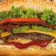 Five Guys — Una hamburguesa con aderezo de tomate y queso, lista para ser disfrutada. Foto de: Marca