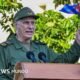 imputación Raúl Castro Estados Unidos — Miguel Díaz-Canel habla en un podio, sosteniendo la bandera de Cuba. Foto de: Getty Images