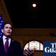 Marco Rubio — Un hombre en traje habla en un evento, con la bandera de Estados Unidos visible detrás de él mientras asistentes toman fotografías. Foto de: The Guardian