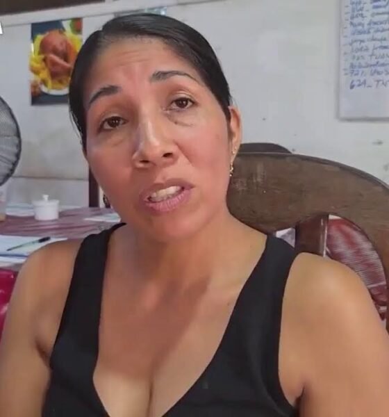 Fondo Social — Una mujer con cabello oscuro y una blusa negra mira hacia la cámara mientras se encuentra sentada en una silla de madera. Foto de: El Búho