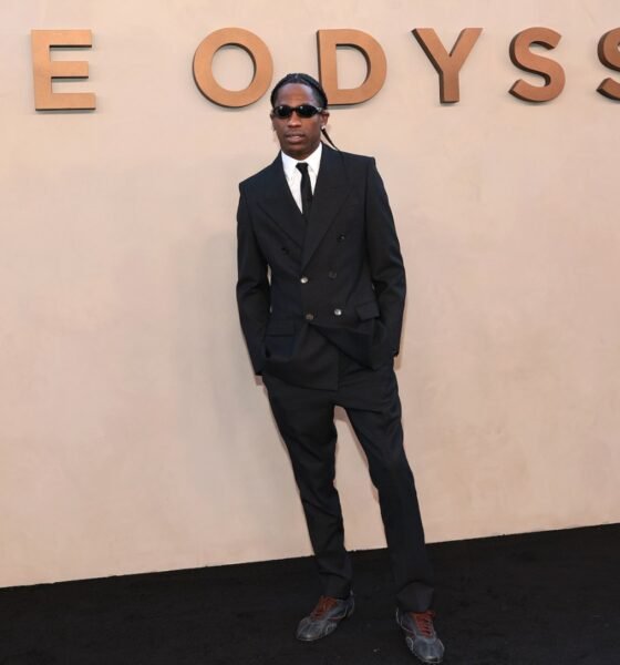 El artista Travis Scott posa frente a un muro con el título de su proyecto 'The Odyssey'. Foto de: Dimitrios Kambouris/Getty Images for Universal Pictures