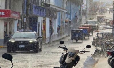 friaje Perú agosto — Vehículos y personas transitan por una calle bajo la lluvia en una zona comercial durante el periodo de friaje en Perú. Foto de: Gestión